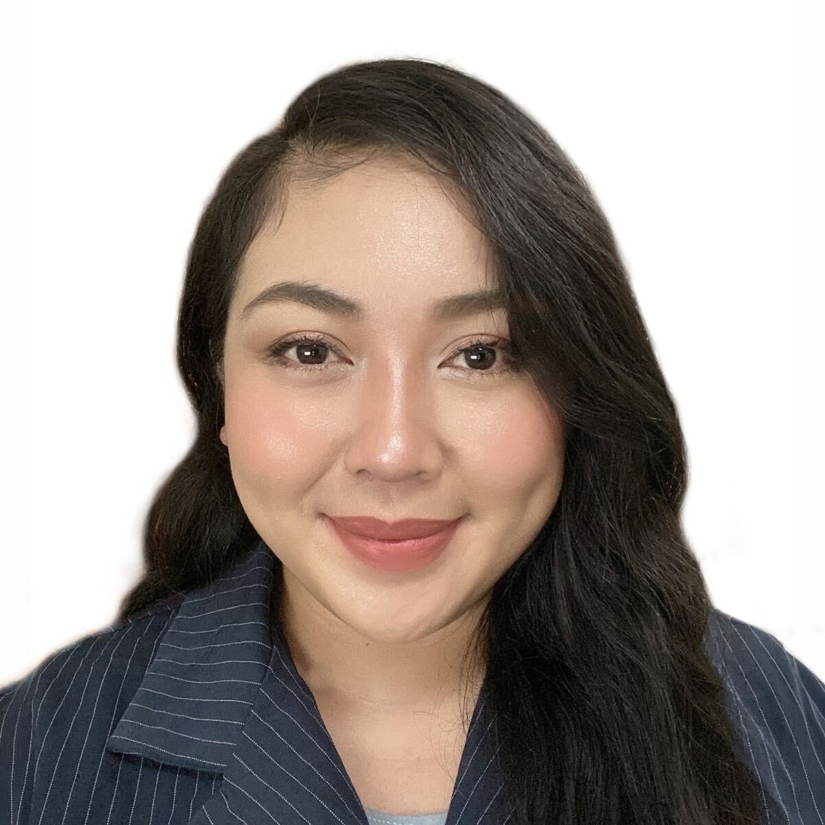 Professional headshot of a woman with long dark hair wearing a navy pinstripe blazer